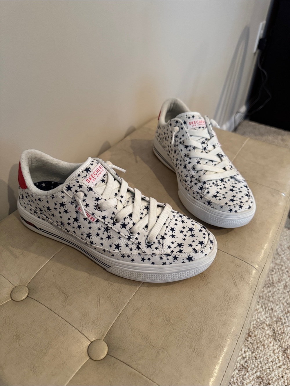 Skechers White Sneakers with Navy Star Print and Red Heel Accent